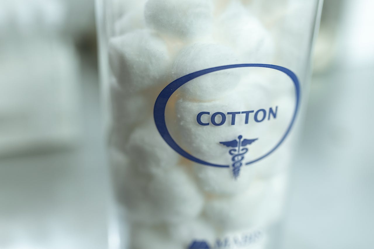 Detailed image of cotton balls in a medical jar, ideal for healthcare themes.